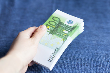 a person gives a pack of Euro currency