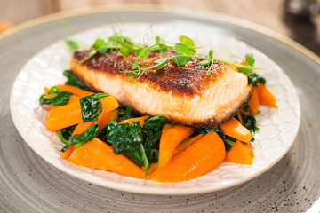 Salmon steak with carrot and spinach
