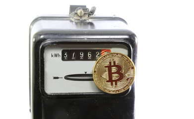 golden BitCoin coin over an electric power meter