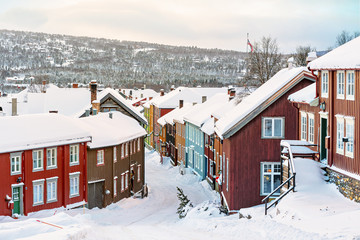 Colorful building facades at a street covered in snow during winter in the city of Roros