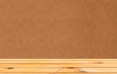 A wooden table with an orange background