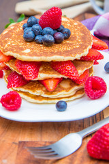 dish with pancakes and strawberry,raspberry and blueberry