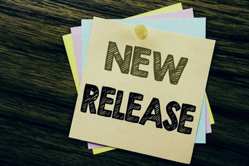 Conceptual hand writing text caption inspiration showing New Release . Business concept for Technology Software Update written on sticky note paper on the wooden background.
