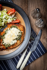 Fried chicken fillet with spinach and cheese.