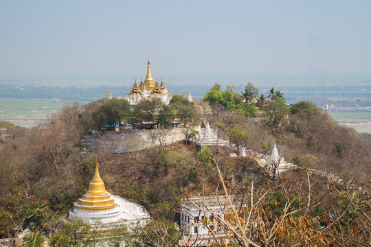 Golden pagoda and stupas on the Sagaing Hill in Mandalay, Myanmar (Burma) on a sunny day.