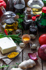 Various ingredients for cooking: oils, sauces, spices and vegetables