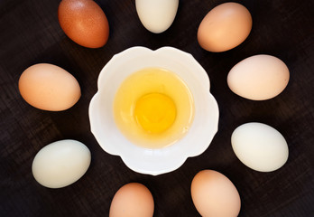 Overhead View of Whole Eggs and One Yolk in the Middle