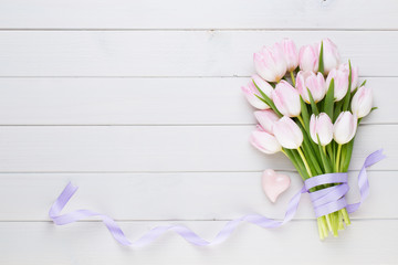 Pink pastel color tulip on the white background. Easter background.