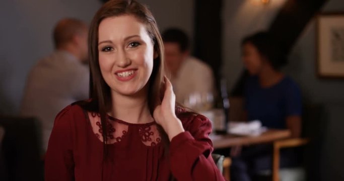 4K Young woman chatting & flirting on a date in restaurant. As seen from her date's point of view