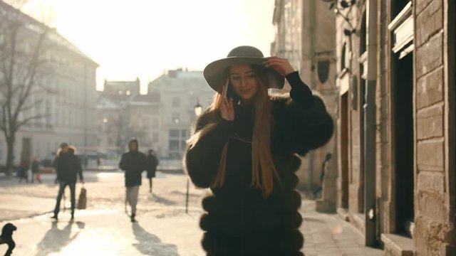 Young girl calling somebody on the phone, talking and smiling happily