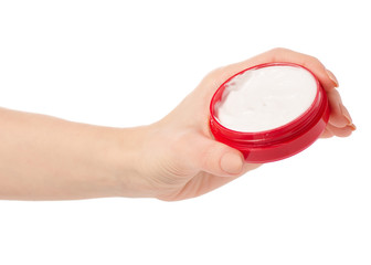 Face body cream in a red jar in hand