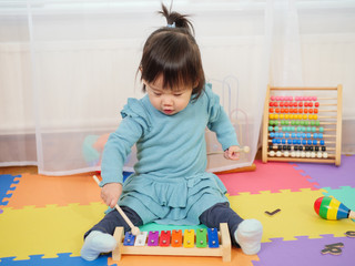 baby girl play xylophone at home