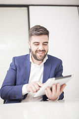 businessman in suit in meeting room with tablet 02