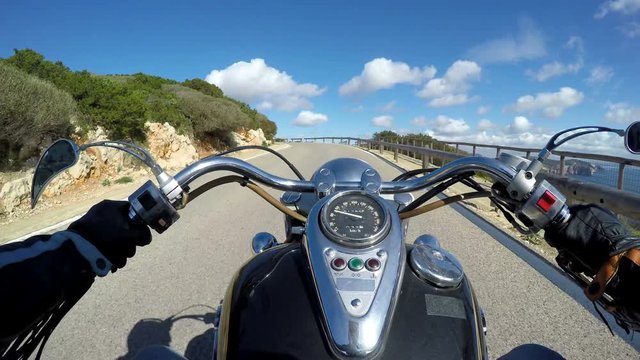 Classic motorcycle riding in Capo Caccia. Sardinia, Italy