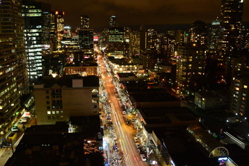 Robson street in Vancouver at nighttime.The busy Robson shopping street lit up at night as shoppers enjoy Vancouver.