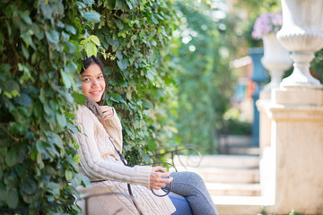 middle age of Asian woman throwing leaves in the air