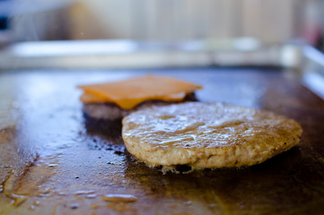 Burger on a stove background. Delicious hamburger cheeseburger. Healthy fresh food cooking