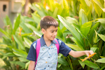 Little boy giving flower to her mother with happy smile together
