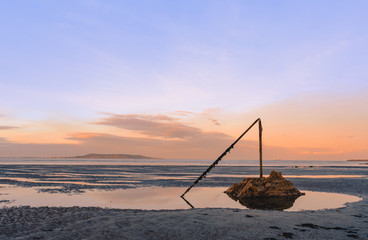 seascape on the east coast of Ireland during the sunset. sand rocks, low tide and colourful sky
