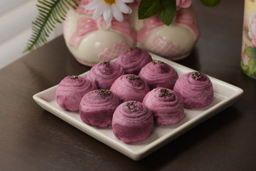 close up asian mini tao mooncakes on white plate