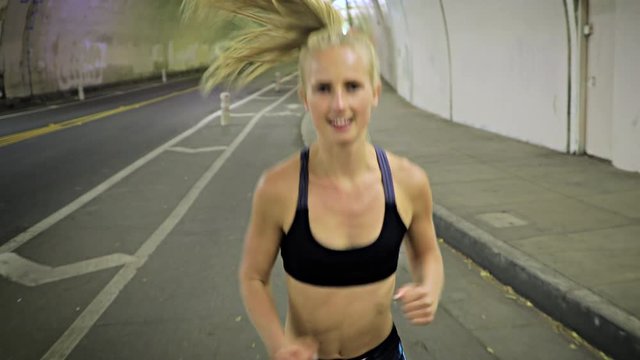 Attractive and fit woman jogging through one of the tunnels that run under Los Angeles.