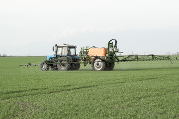 Fototapeta premium Tractor with a spray device for finely dispersed fertilizer.