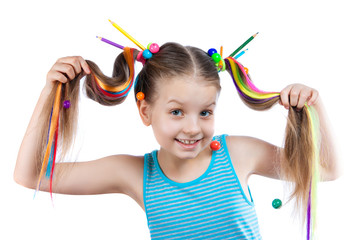 Portrait of a funny girl with colorful strands in her hair. Colored pencils, beads, colored strands of hair in her hair.