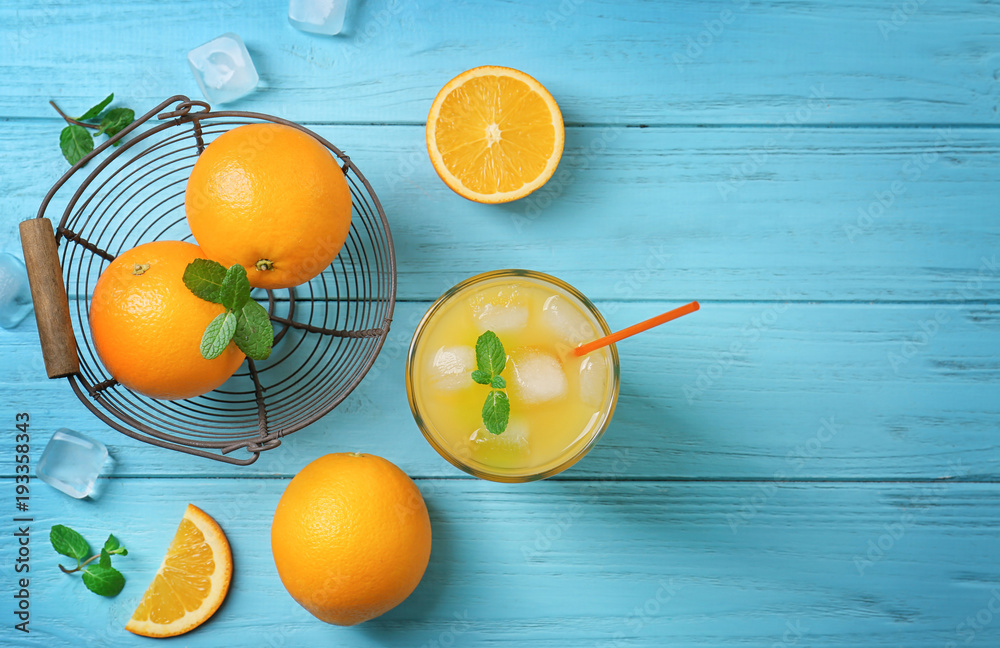 Wall mural beautiful composition with fresh orange juice on wooden table, top view