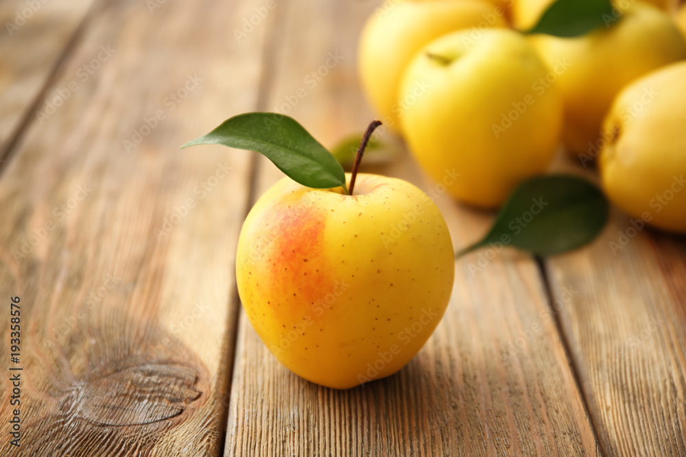 Sticker ripe yellow apple on wooden table