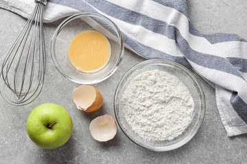 Glass bowls and products on grey background