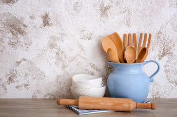 Set of cooking utensils and dishware on table