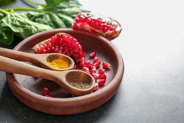 Plate with spoons and products on table