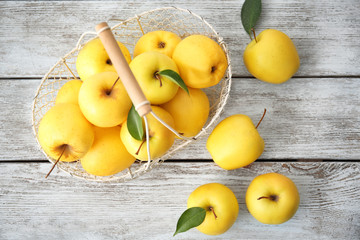 Ripe yellow apples on wooden background