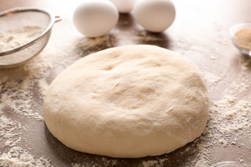 Raw dough on kitchen table