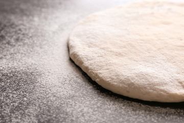 Raw dough on kitchen table, closeup