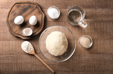 Raw dough and ingredients on kitchen table