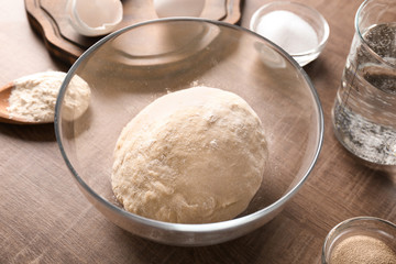 Raw dough and ingredients on kitchen table