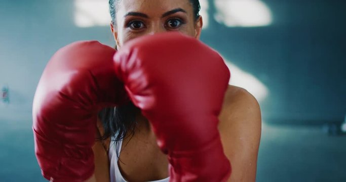 Beautiful athletic woman training boxing in the gym