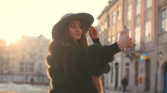 Young teenage girl taking photo or making selfie