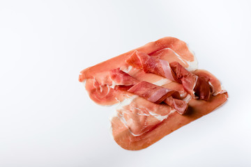 Spanish serrano ham isolated on white