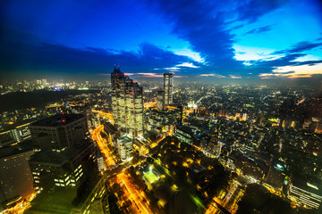 Obraz premium Asia Business concept for real estate and corporate construction - panoramic modern city skyline aerial night view of Shinjuku and Tokyo Metropolitan Expressway under twilight sky in Tokyo, Japan