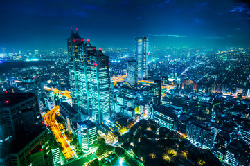 Asia Business concept for real estate and corporate construction - panoramic modern city skyline aerial night view of Shinjuku and Tokyo Metropolitan Expressway under twilight sky in Tokyo, Japan
