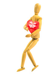 wooden puppet hugging red paper heart isolated on white background