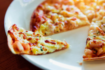 Tortilla Pizza with mozzarella cheese, imitation crab stick, sweet corn and pineapple.