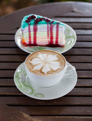 Coffee leaf and place the cake on a wooden table.