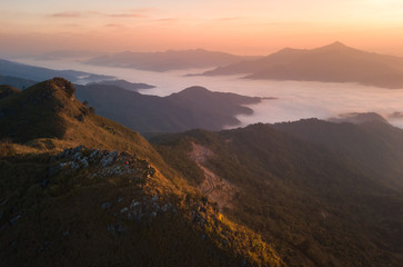 Obraz na płótnie Canvas morning mountain view with sunbeam and haze at Doi Pha Tang chiang rai thailand