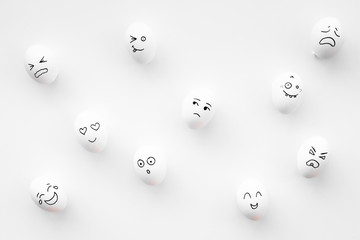 Basic emotions concept. Faces drawn on eggs. Happy, smile, sad, angry, in love. White background...