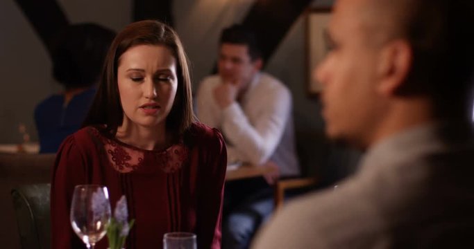 4k, A disagreeing couple having a heated argument while on date at a restaurant. Slow motion.