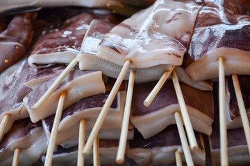 fresh squid fillet with skewers on the market.Thailand
