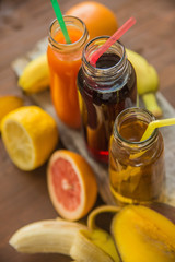 Delicious array of fresh fruit juices served in tall glasses made from liquidised orange, kiwifruit with peppermint, and strawberries for healthy summer treats rich in vitamins